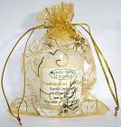 The three wise men Gold organza gift bag,
with a Frankincense and Myrrh candle in a glass.